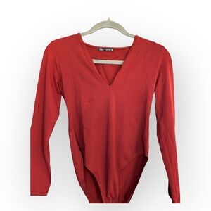 Red long sleeve bodysuit with V-neck and high cut leg, made